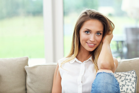 Picture of young woman on couchの写真素材