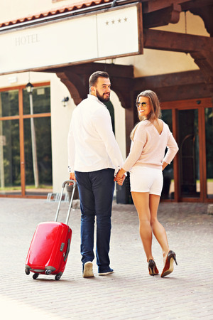 Picture of young couple entering hotelの写真素材