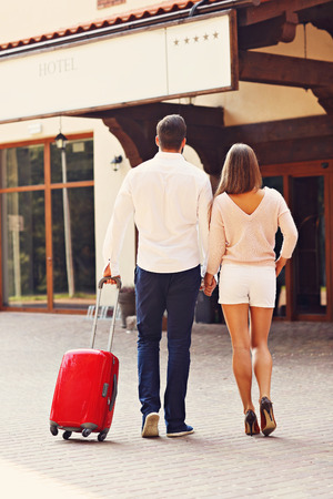 Picture of young couple entering hotelの写真素材