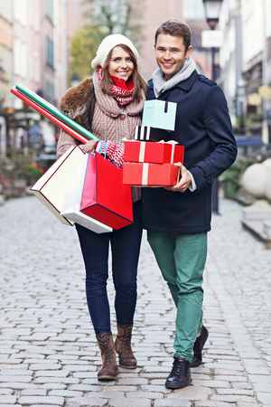 Picture showing young couple doing Christmas shopping in the cityの写真素材
