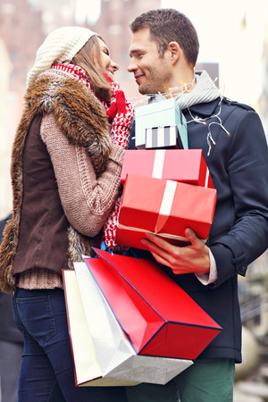 Picture showing young couple doing Christmas shopping in the cityの写真素材