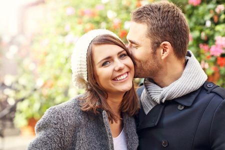 Picture of happy couple kissing in the cityの写真素材