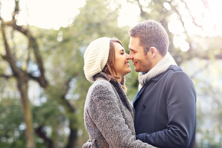 Picture of young couple kissing in the parkの写真素材