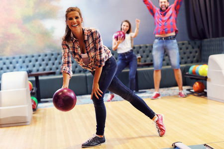 Picture showing friends playing bowlingの写真素材