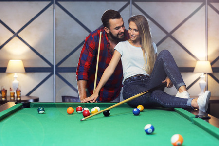 Picture of pretty couple playing billardsの写真素材
