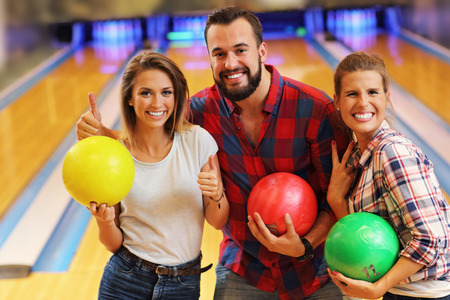 Picture showing friends playing bowlingの写真素材