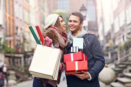 Picture showing young couple doing Christmas shopping in the cityの写真素材