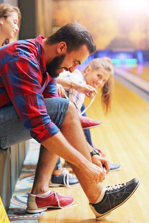 Picture showing friends putting on bowling shoesの写真素材