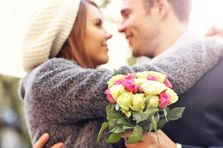 Picture of young couple kissing in the parkの写真素材
