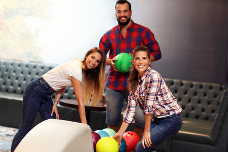 Picture showing group of friends playing bowlingの写真素材