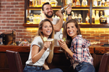 Picture of friends having drinks in barの写真素材