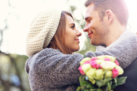 Picture of young couple kissing in the parkの写真素材
