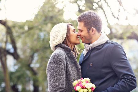 Picture of young couple kissing in the parkの写真素材