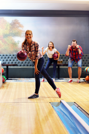 Picture showing friends playing bowlingの写真素材