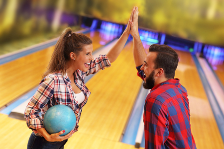 Picture showing friends playing bowlingの写真素材
