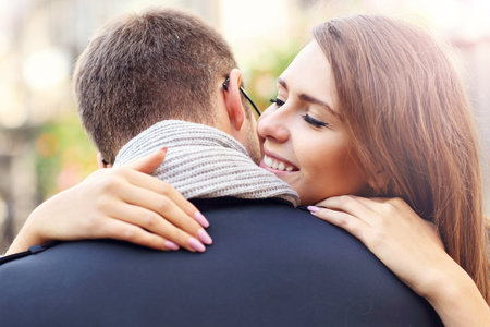 Picture showing happy couple hugging in the cityの写真素材