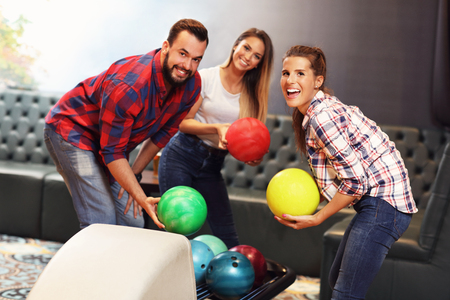 Picture showing group of friends playing bowlingの写真素材
