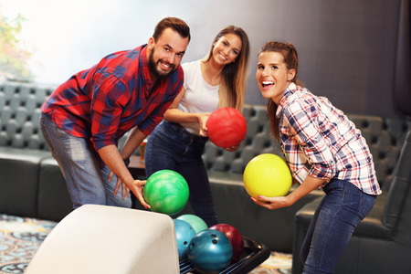 Picture showing group of friends playing bowlingの写真素材