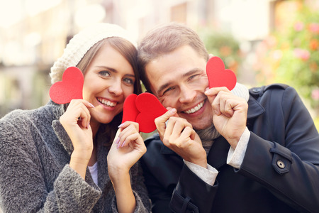 Picture of happy couple having fun with heartsの写真素材