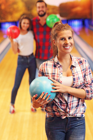 Picture showing friends playing bowlingの写真素材
