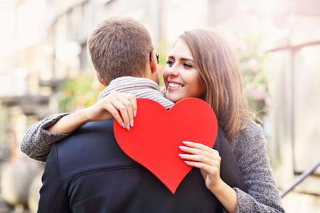 Picture showing happy couple hugging with heart in the cityの写真素材