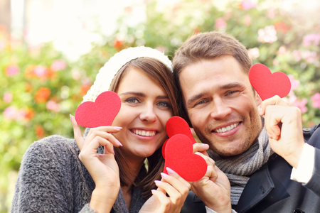 Picture of happy couple having fun with heartsの写真素材