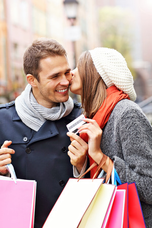 Young couple shopping in the city with credit cardの写真素材