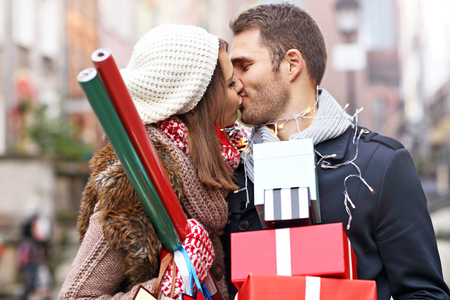 Picture showing young couple doing Christmas shopping in the cityの写真素材