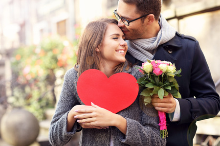 Picture of young couple with flowers and heartの写真素材