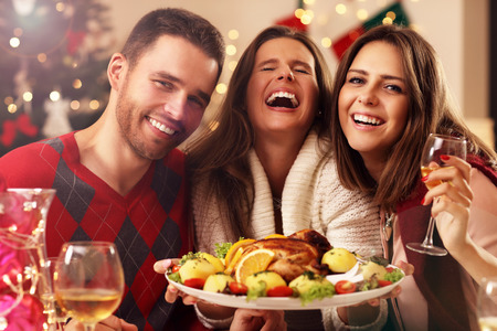 Picture showing group of friends celebrating Christmas at homeの写真素材