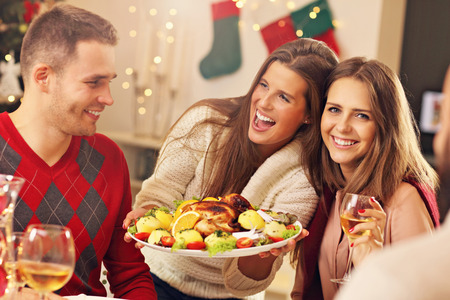 Picture showing group of friends celebrating Christmas at homeの写真素材