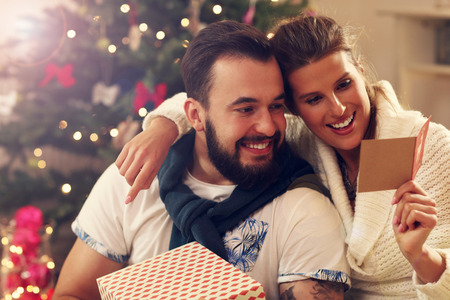 Picture showing young couple celebrating Christmas at homeの写真素材