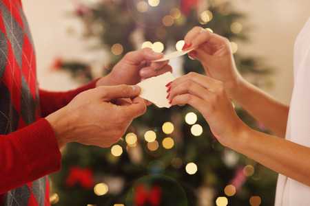 Cuple sharing Christmas wafer in traditional Polish wayの写真素材