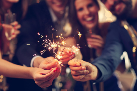 Picture showing group of friends having fun with sparklersの写真素材