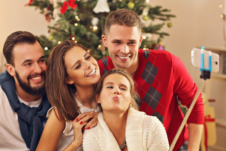 Picture showing group of friends taking selfie during Christmasの写真素材