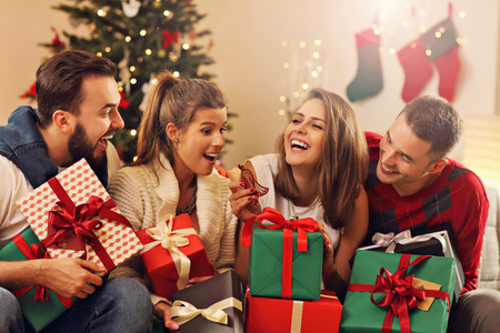 Picture showing group of friends celebrating Christmas at homeの写真素材