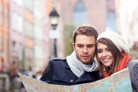 Picture showing young couple sightseeing with mapの写真素材