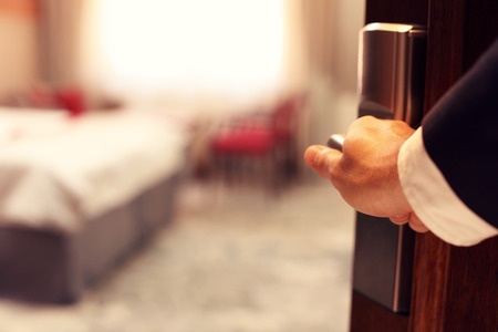 Picture showing hand of businessman opening hotel room