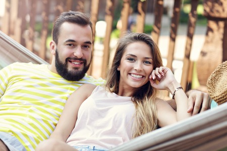 Picture showing happy couple resting on hammockの写真素材