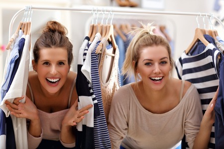 Happy women shopping for clothesの写真素材