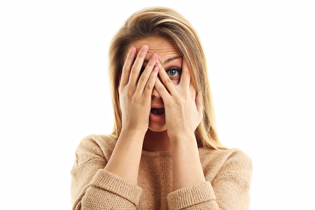 Afraid woman looking at camera isolated on a white backgroundの写真素材