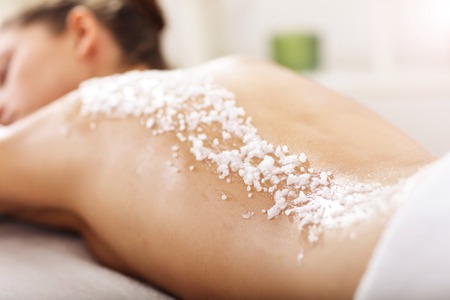 Beautiful woman having exfoliation treatment in spaの写真素材