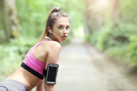 Woman jogging in the forestの写真素材