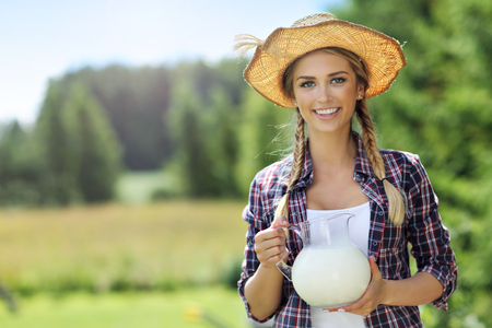 Young woman with fresh organic milkの写真素材