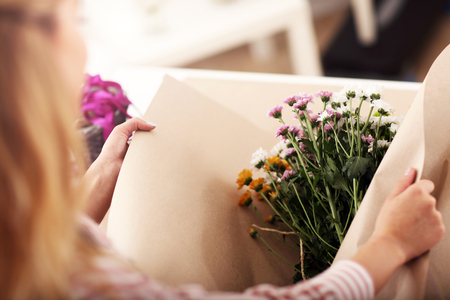Female florist working in flower shopの写真素材