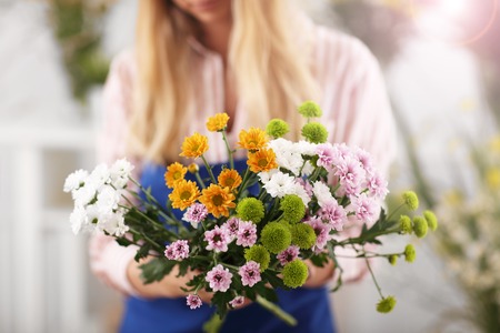 Female florist working in flower shopの写真素材