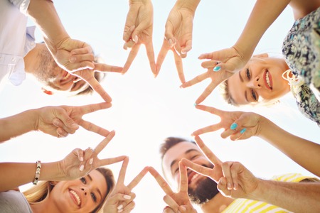 Friends group having fun together on grassの写真素材