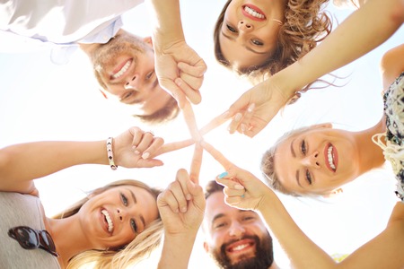 Friends group having fun together on grassの写真素材