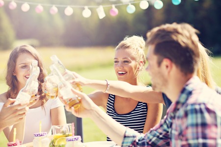 Friends having barbecue party in backyardの写真素材
