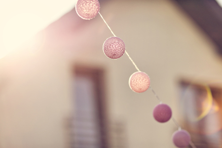 Lanterns in the garden with house in backgroundの写真素材